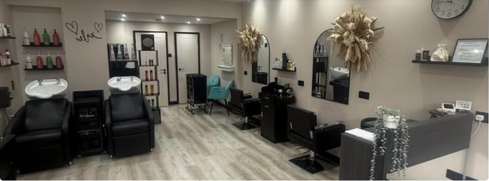 Inside The Stylist Hair Studio: black chairs, mirrors and a calm neutral room